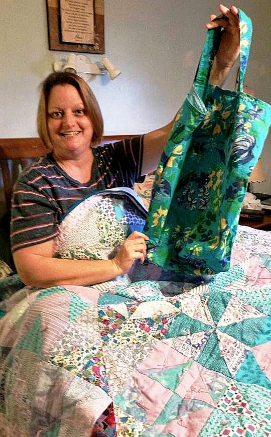 Nancy Smith with quilt and totebag