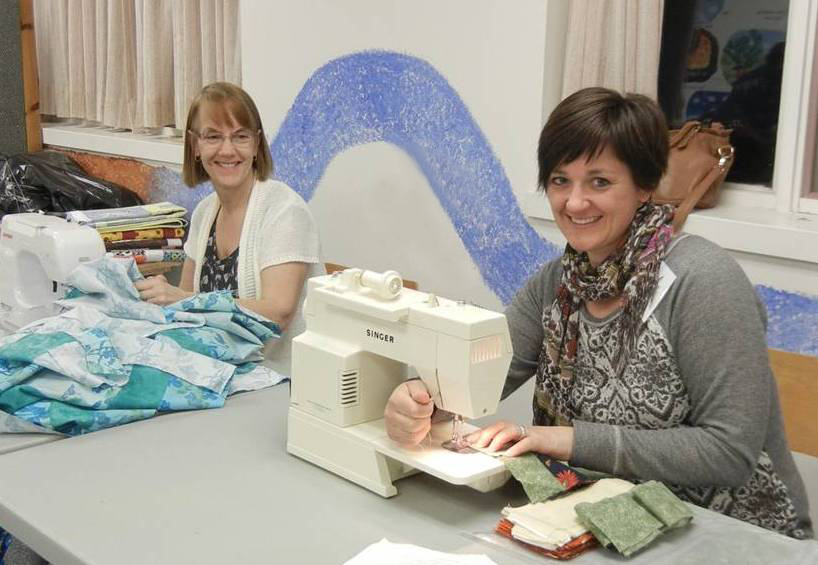 Volunteers from the Beacon Hill Friends Group (Ottawa) sewing quilt pieces