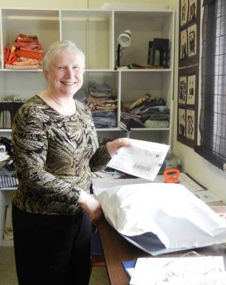 Volunteer preparing a quilt package to be mailed out